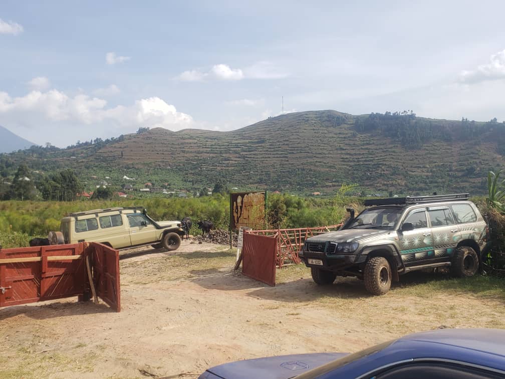 Safari vehicles at mountain base camp